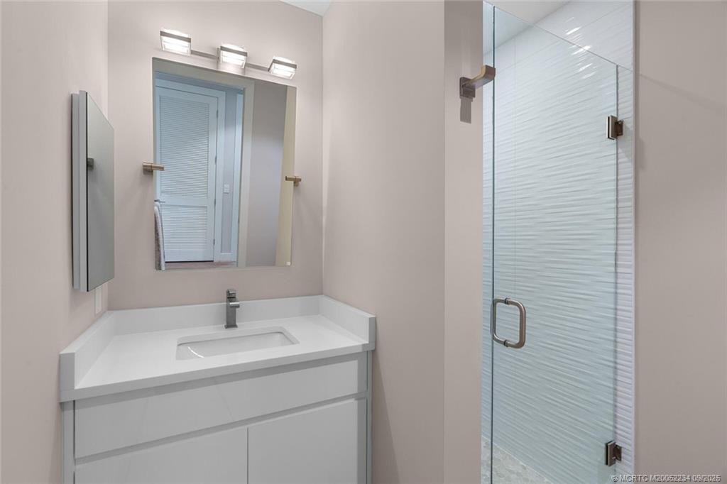 Undisclosed Address Stuart, FL 34994 - Photo 26 of 58 a bathroom with a sink and mirror