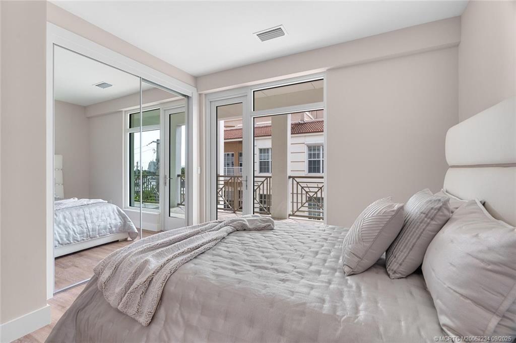 Undisclosed Address Stuart, FL 34994 - Photo 41 of 58 a bedroom with a large bed and a large window