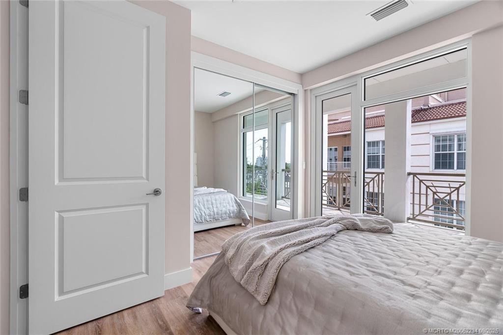 Undisclosed Address Stuart, FL 34994 - Photo 42 of 58 a bedroom with a bed and a large window