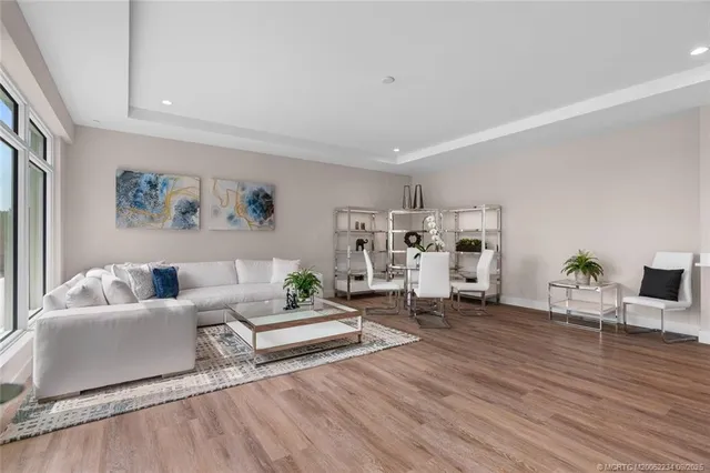 a living room with furniture and view of kitchen