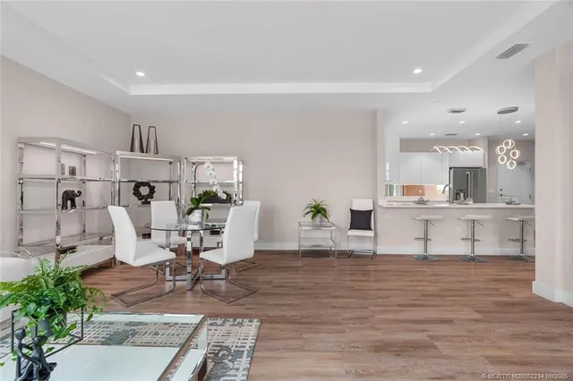a living room with furniture a flat screen tv and a large window