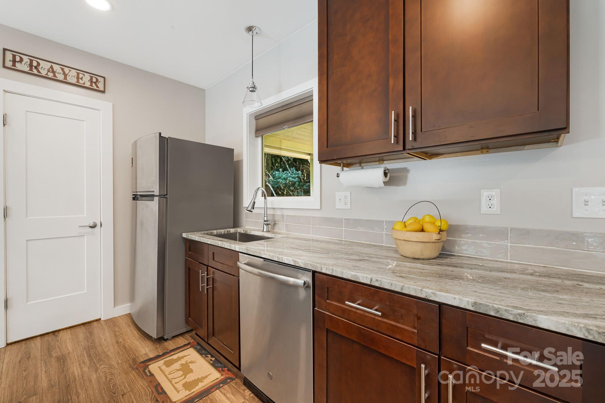 1101 Line Runner Ridge Road Rosman, NC 28772 - Photo 12 of 47 a kitchen with stainless steel appliances granite countertop a refrigerator and a sink