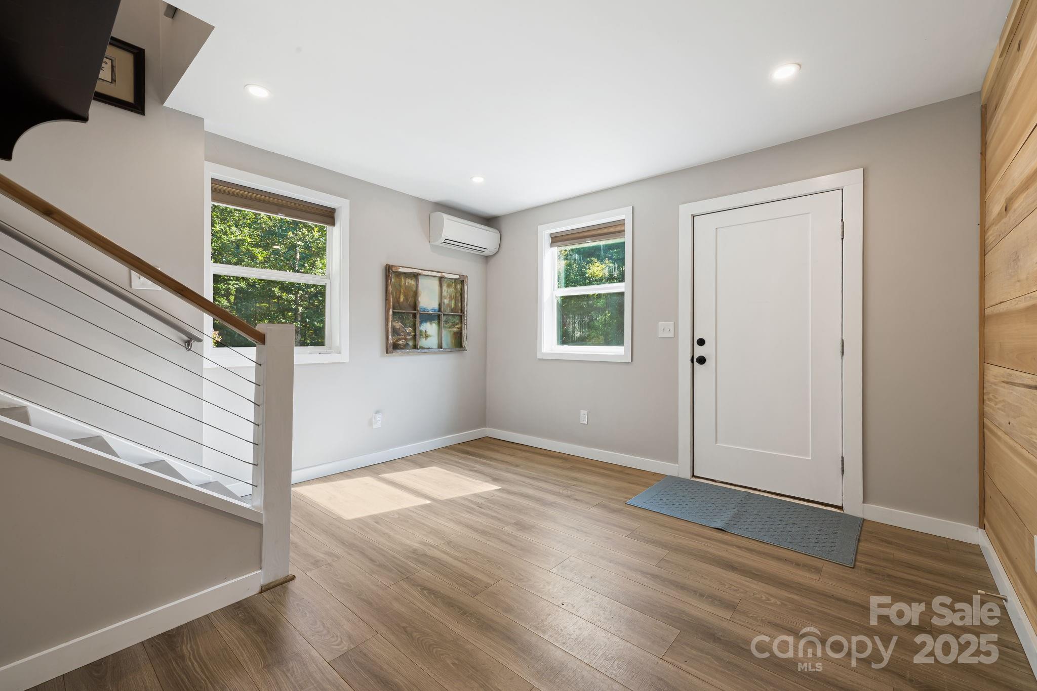 1101 Line Runner Ridge Road Rosman, NC 28772 - Photo 22 of 47 a view of an empty room with wooden floor and a window