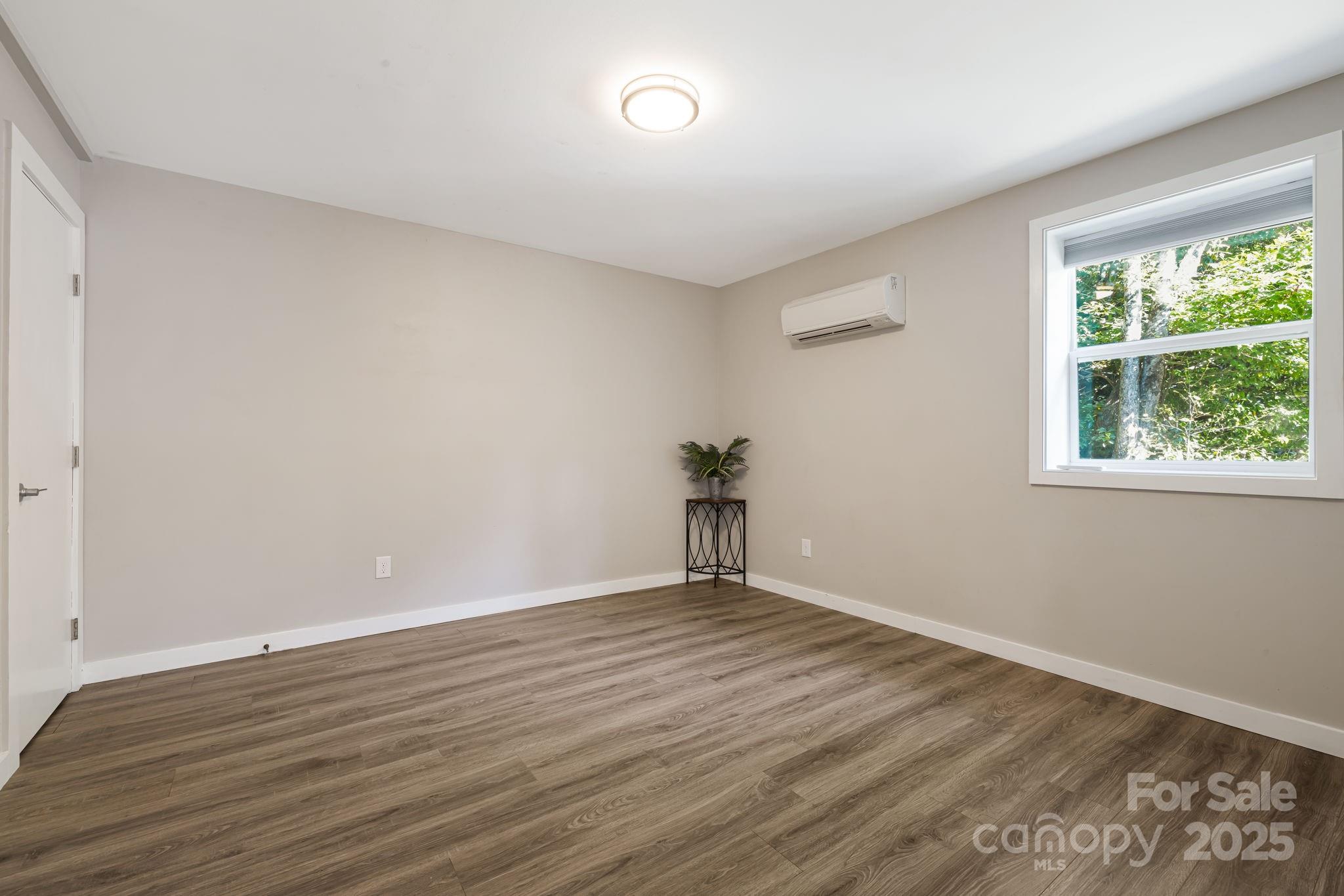 1101 Line Runner Ridge Road Rosman, NC 28772 - Photo 24 of 47 a view of an empty room with wooden floor and a window