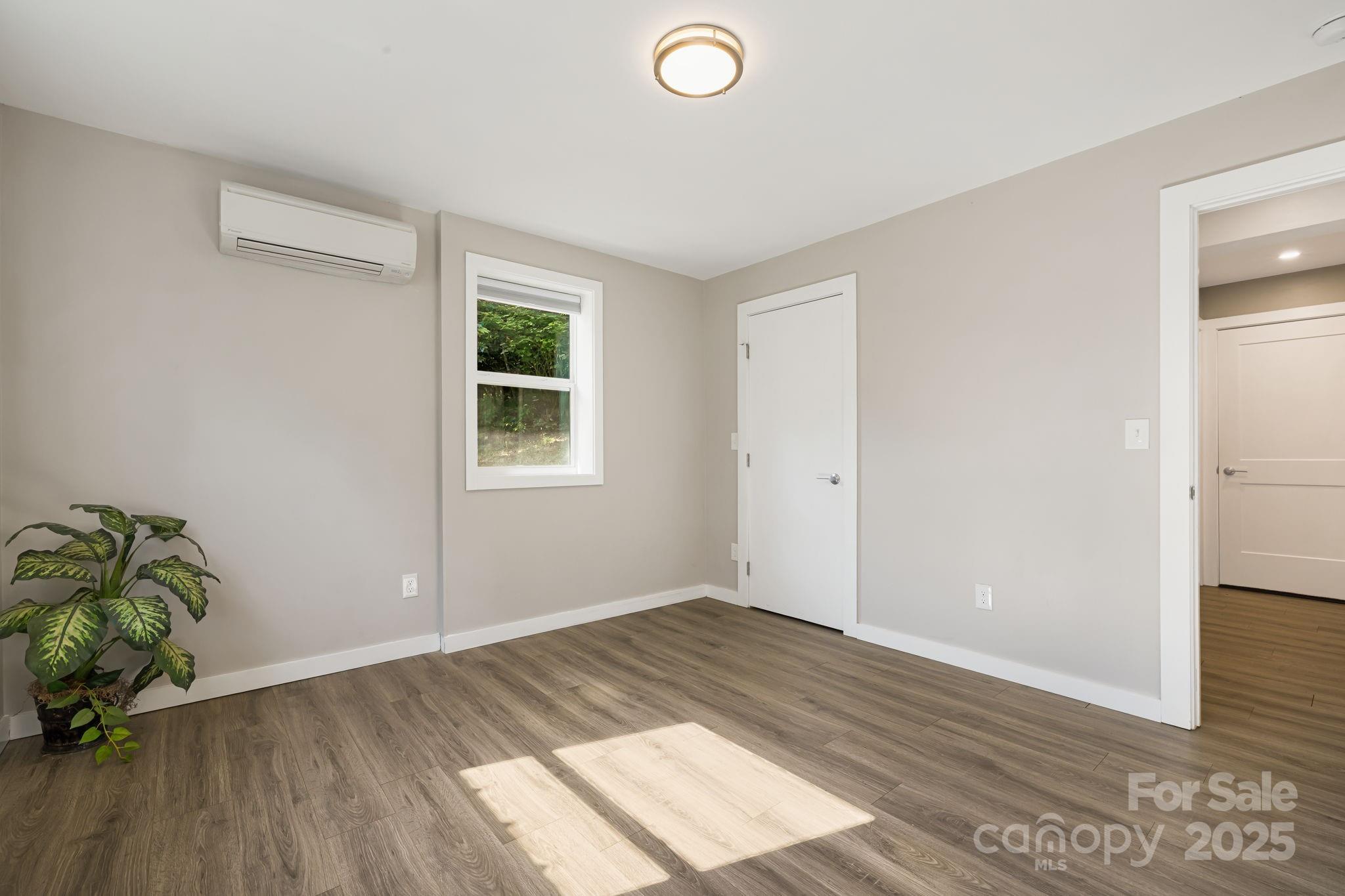 1101 Line Runner Ridge Road Rosman, NC 28772 - Photo 28 of 47 an empty room with wooden floor and windows