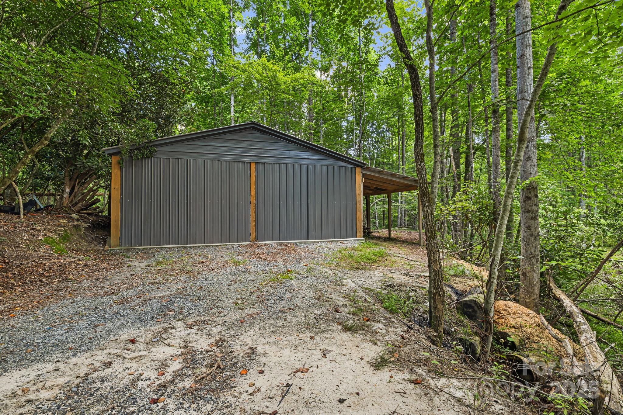 1101 Line Runner Ridge Road Rosman, NC 28772 - Photo 34 of 47 a backyard of a house with large trees and wooden fence