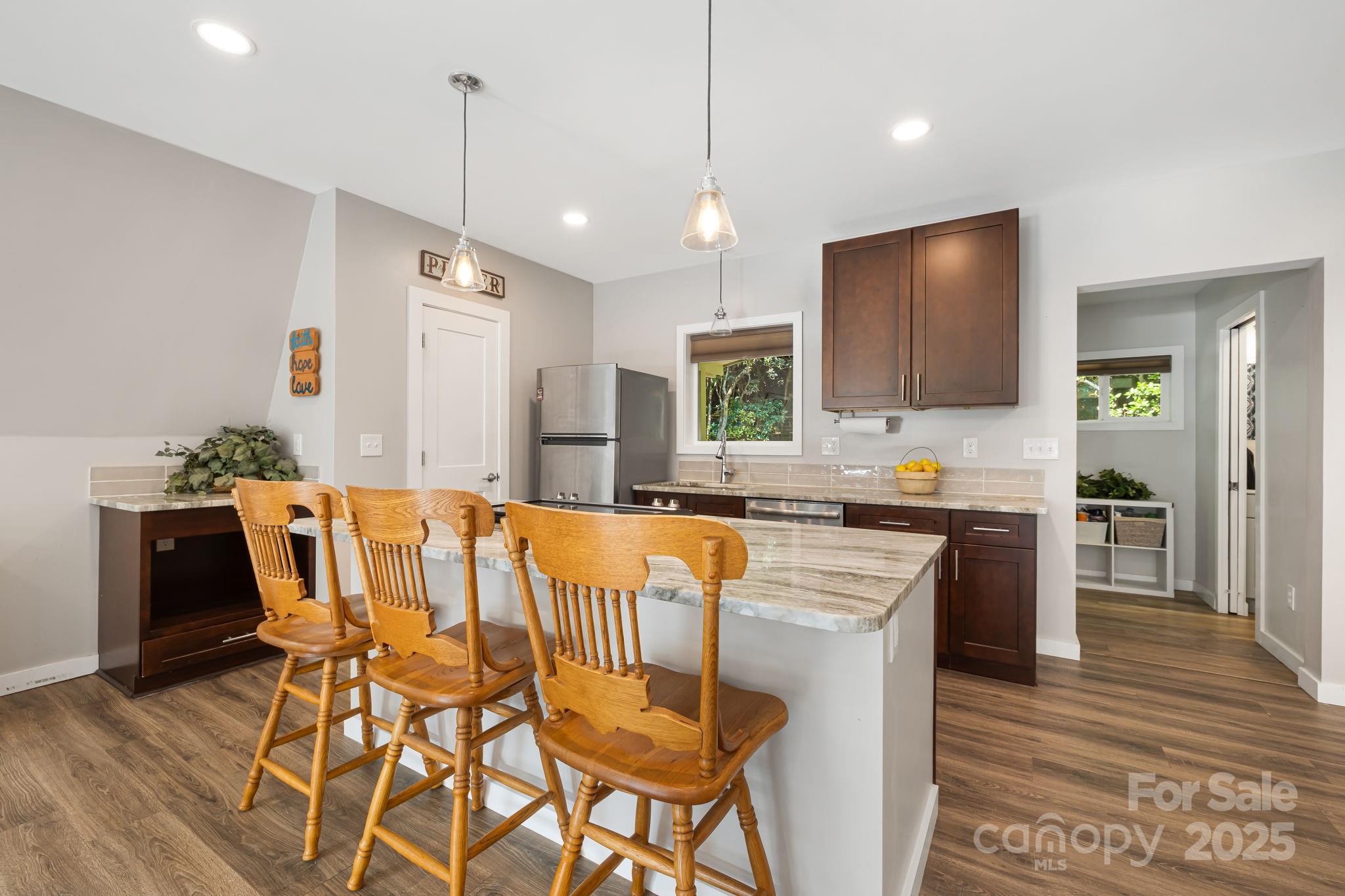 1101 Line Runner Ridge Road Rosman, NC 28772 - Photo 10 of 47 a kitchen with a table chairs refrigerator and microwave