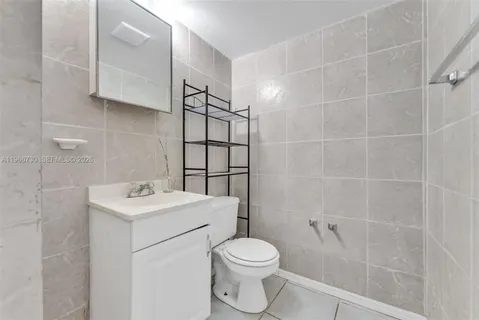 a white toilet sitting next to a bathroom sink