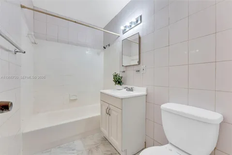 a room with a bed and a potted plant