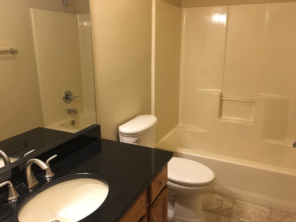 195 Barre Road Phillipston, MA 01331 - Photo 3 of 9 a bathroom with a granite countertop sink toilet and a mirror
