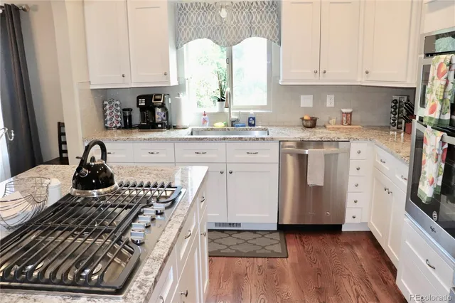 a kitchen with a stove a sink and a refrigerator
