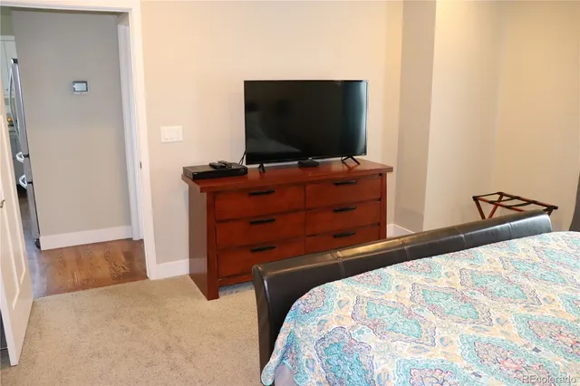 a bedroom with a bed and flat screen tv