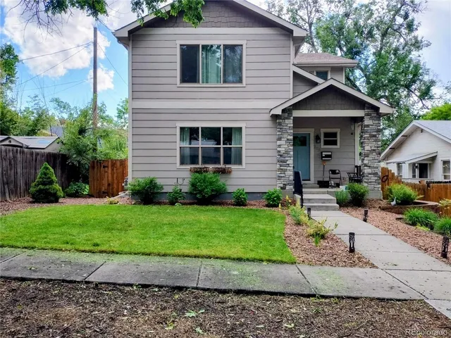 a front view of a house with a yard and a garage