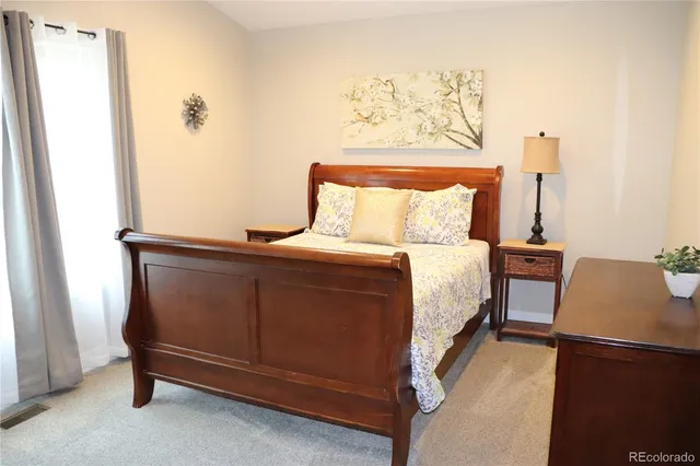 a bedroom with a bed and a dresser