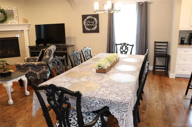 a view of a livingroom with furniture flat screen tv and wooden floor