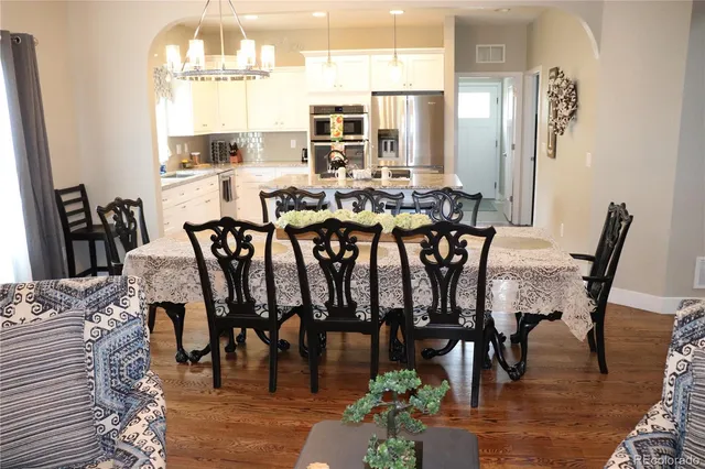 a view of a dining room with furniture window and wooden floor