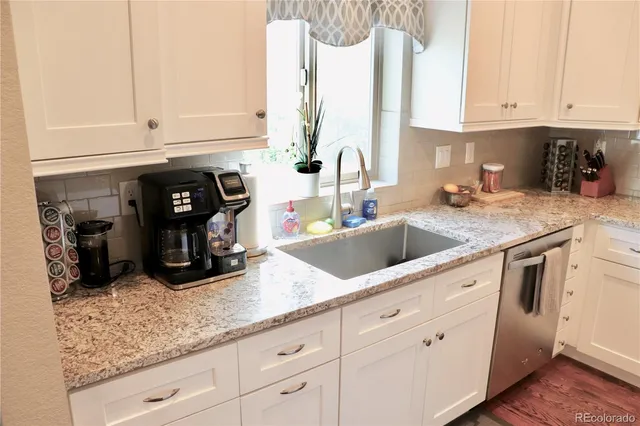 a kitchen with stainless steel appliances granite countertop a sink and cabinets