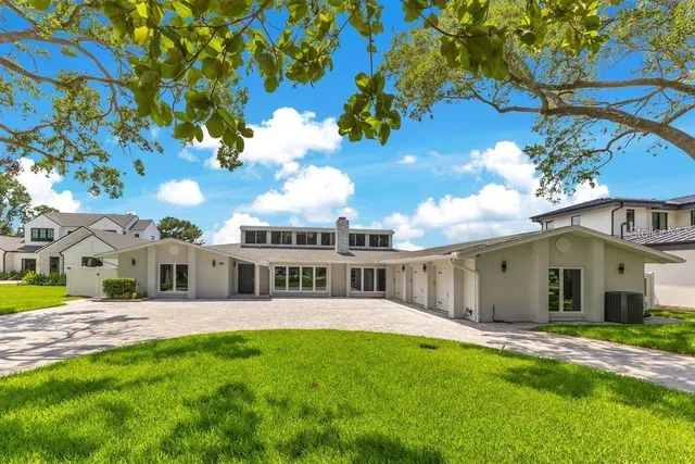 a view of a house with a backyard