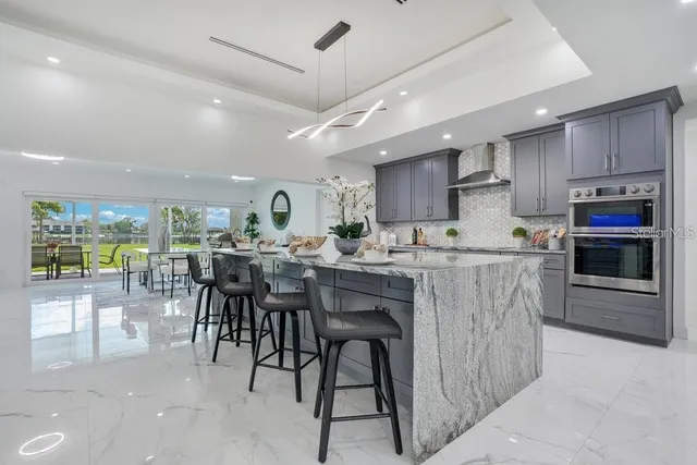 a kitchen with a sink and chairs