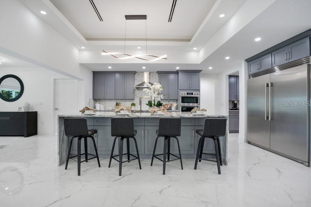 49 Interlaken Road Orlando, FL 32804 - Photo 15 of 61 a kitchen with a sink and chairs