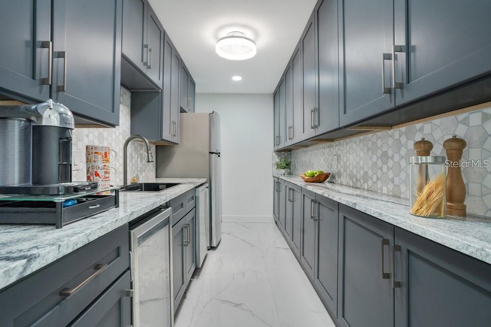 49 Interlaken Road Orlando, FL 32804 - Photo 16 of 61 a kitchen with stainless steel appliances granite countertop a sink a stove and a wooden floors