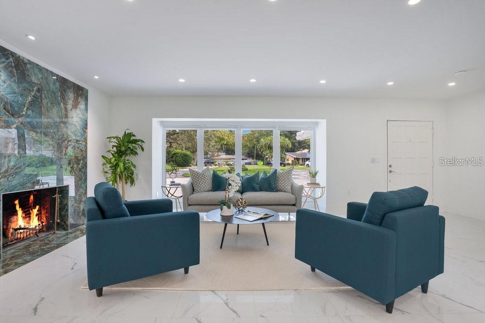 49 Interlaken Road Orlando, FL 32804 - Photo 22 of 61 a living room with furniture potted plant a fireplace and a window