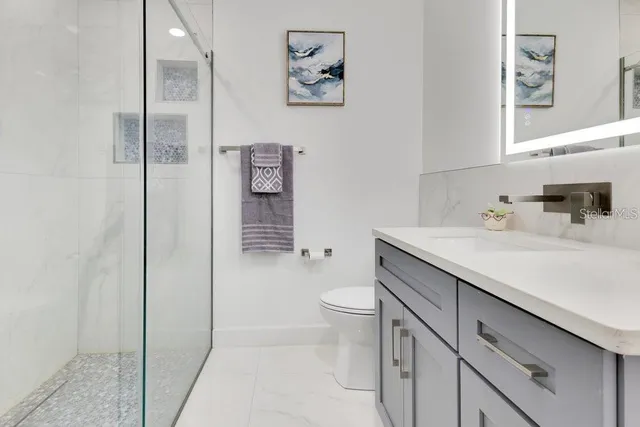 a spacious bathroom with a tub sink shower and mirror