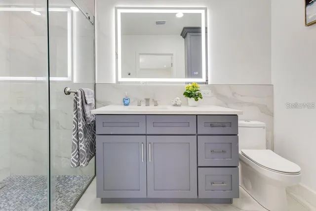 a spacious bedroom with a bed and a window