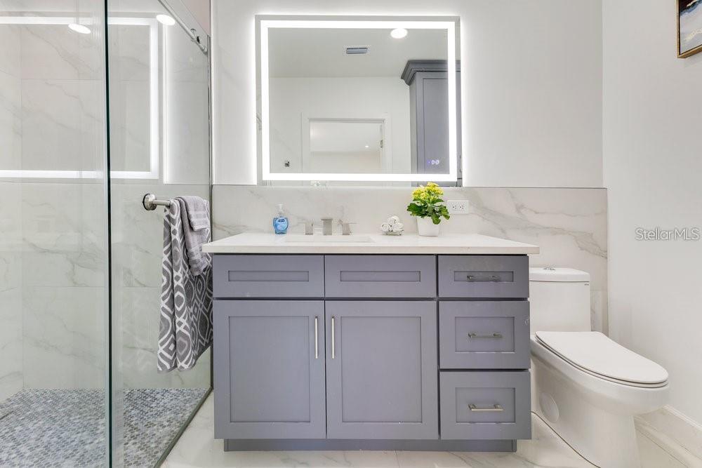 49 Interlaken Road Orlando, FL 32804 - Photo 27 of 61 a bathroom with a sink a toilet and mirror