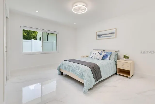 a spacious bedroom with a bed and a window