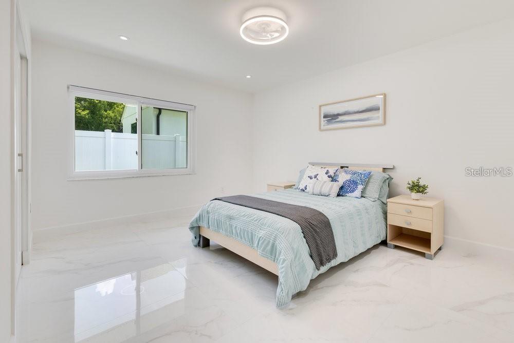 49 Interlaken Road Orlando, FL 32804 - Photo 29 of 61 a spacious bedroom with a bed and a window