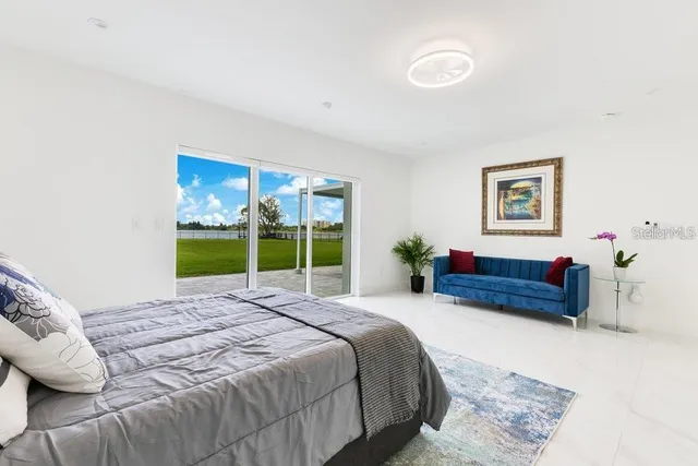 a bedroom with a bed and a potted plant