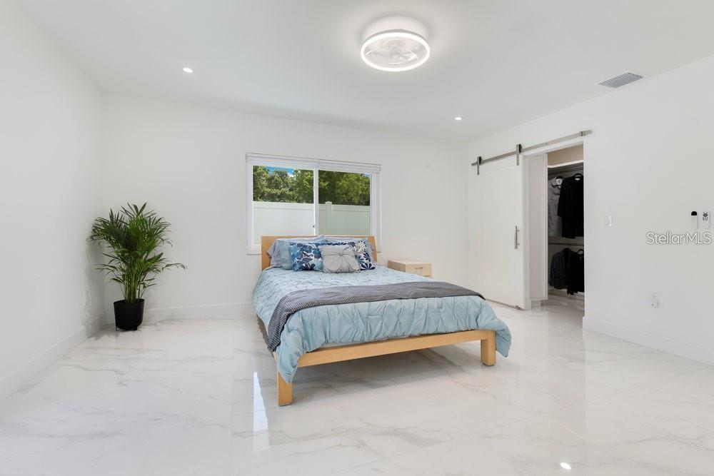 49 Interlaken Road Orlando, FL 32804 - Photo 32 of 61 a bedroom with a bed and a potted plant