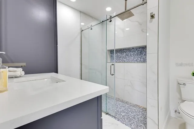 a view of a white house with a big yard and a large tree