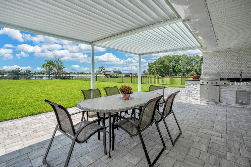49 Interlaken Road Orlando, FL 32804 - Photo 45 of 61 a view of a patio with a table chairs and a backyard