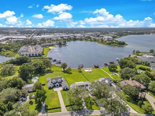 a view of a lake with table and chairs
