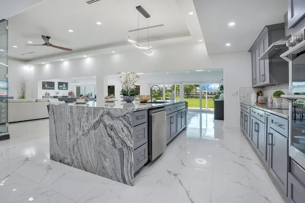 a large kitchen with stainless steel appliances lots of counter space and breakfast area