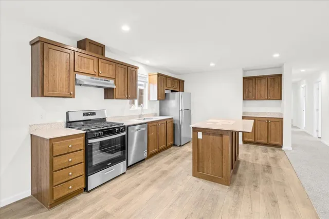 a view of kitchen with furniture and refrigerator