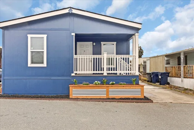 a front view of a house with entryway and wooden floor
