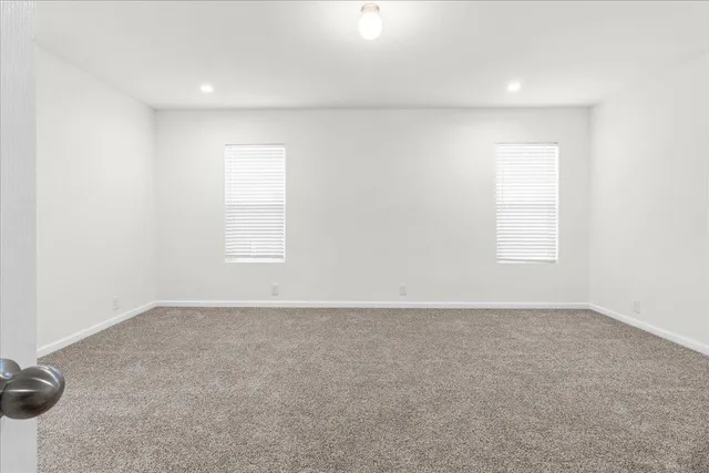 an empty room with a empty space and windows
