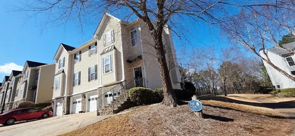 a view of a house with backyard and sitting area