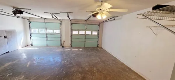 a view of a room with wooden floor and fan