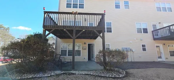 a view of a porch with a table and chairs