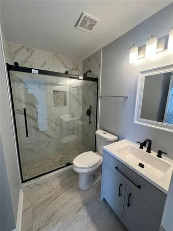 a bathroom with a sink toilet and shower