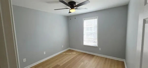 a view of room with window and ceiling fan