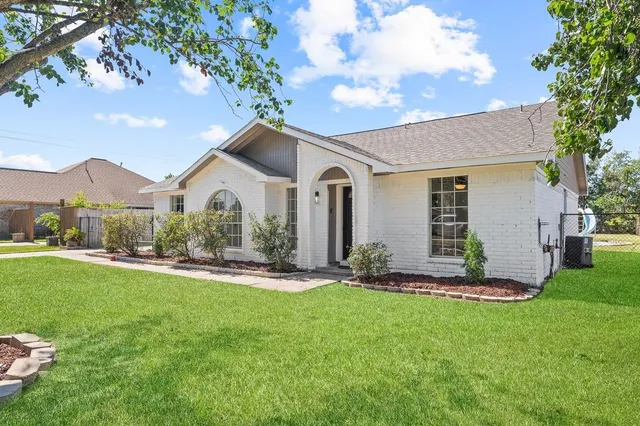 a front view of a house with a yard and pathway