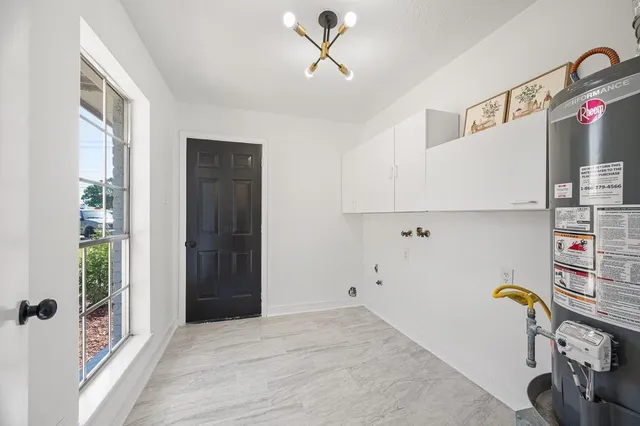 a view of empty room with wooden floor and window