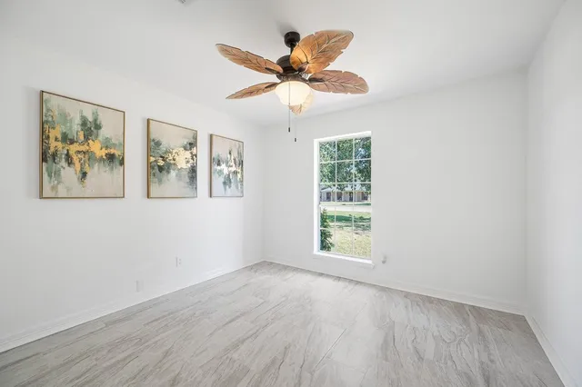 a view of a hallway with wooden floor and closet