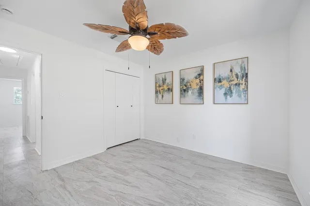a bathroom with a granite countertop sink a toilet and a mirror