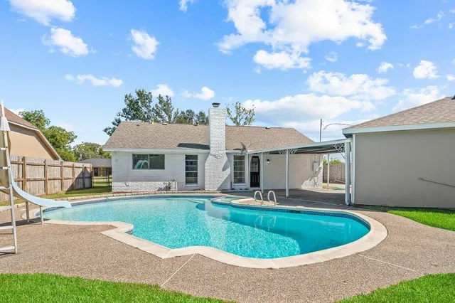 a house view with a sitting space and garden